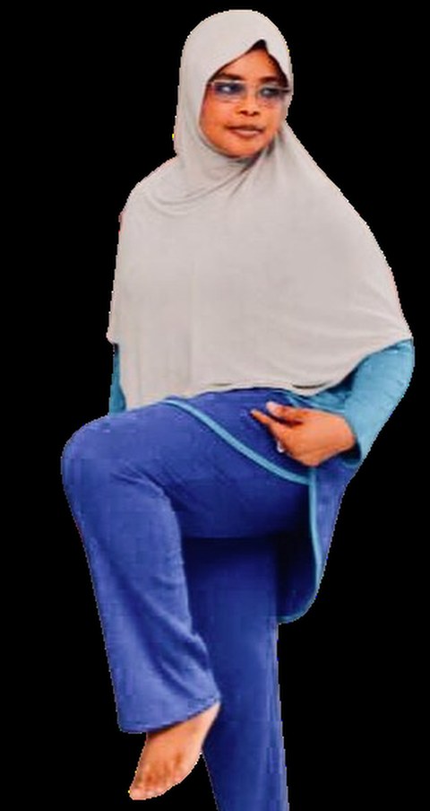 Hajjia Fatima Umar — founder of Rhythm N Flow, balanced on one leg while teaching a class