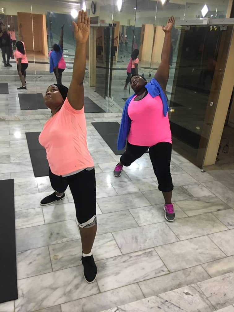 Rhythm N Flow women's fitness class — dancers mid-motion in a fun, energetic session