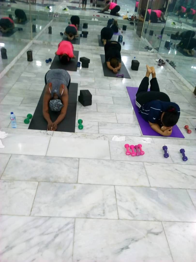 Rhythm N Flow yoga class — participants stretching on the studio floor